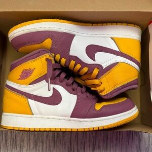 These are Nike high dunks that are gold and purple.